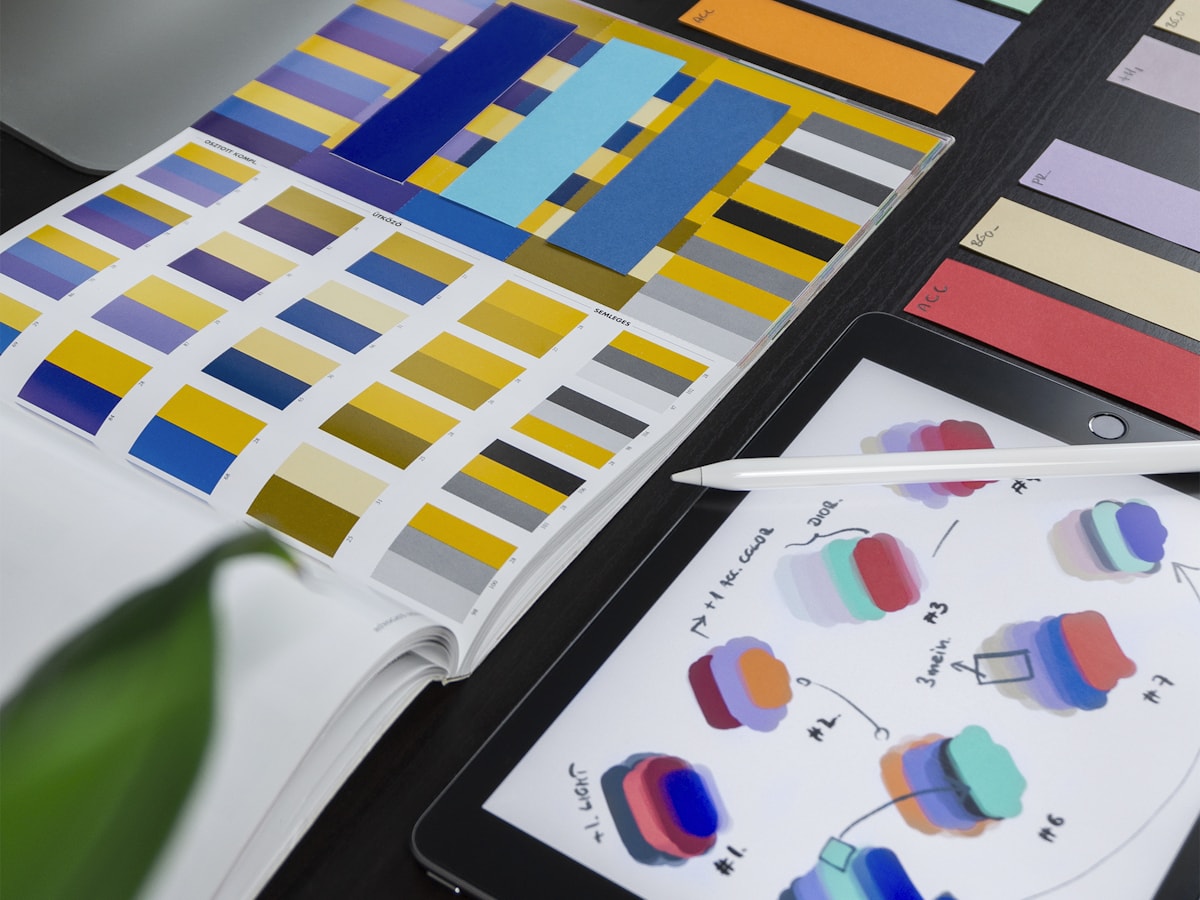 Colour and brand design materials arranged on a creative workspace