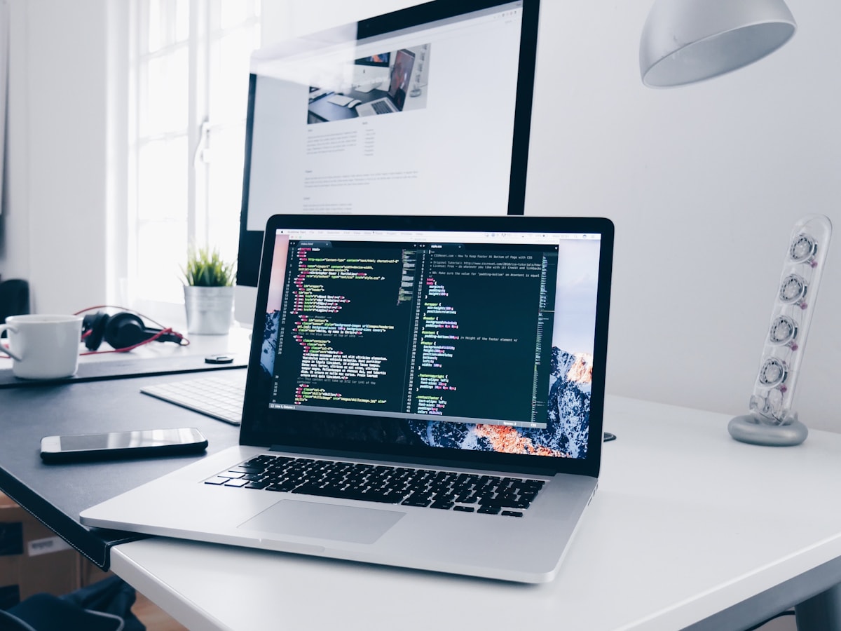 Website development workspace with code displayed on a laptop